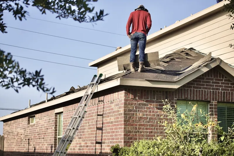 Professional roofer working on a residential roof in San Carlos
